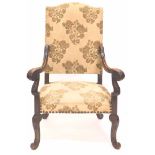 An early 19thC carved French walnut open armchair, in 17thC style, with floral tapestry upholstery,