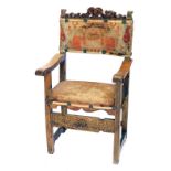 An 18thC continental walnut armchair, with woolwork back and seat.