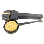 An early 20thC ebonised banjo, in canvas case. (AF)