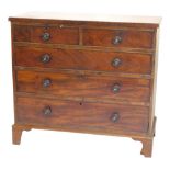 A Victorian flame mahogany chest of two short and three long graduated drawers, with knob handles an