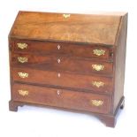 A George III flame mahogany bureau, with fall flap resting on lopers revealing a fitted interior, ov