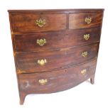 A George III mahogany bow front chest of two short and three long graduated drawers, with brass soli