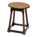 An early 19thC mahogany stool, with oval top, turned legs and stretchers, 42cm high, 33cm oval.