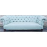 A Victorian Chesterfield sofa, with green patterned upholstery, and turned walnut legs, 200cm wide.