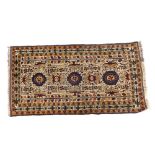 A Persian type rug, with an all over design of medallions, stars, and other geometric devices, on a