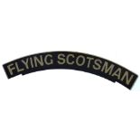 An arched railway engine sign The Flying Scotsman, on wooden backing, painted on black ground with g