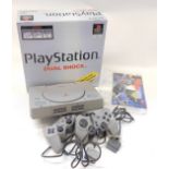 A Playstation model SCPH 7502B, with dual shock controller and accessories, boxed.