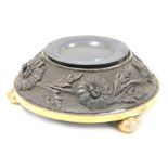 A late 19thC silver plate and brass desk stand, of circular form, embossed with flowers and leaves,