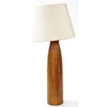A late 20thC wooden table lamp, of tapering form, with a cream shade, approx 71cm high. (AF)