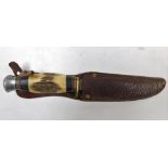 A William Rogers steel and bone handled hunting knife, leather sheathed, 23cm wide.