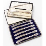 A set of six George V silver handled cake knives, cased, Sheffield 1918, together with a silver hand