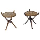 A near pair of African folding occasional tables, the circular tops carved with a rhinoceros, elepha