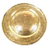 A 17thC brass dish, a central convex roundel engraved with a warrior, Neptune, animals and cherubs,