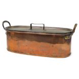 A large two handled copper fish kettle, of plain oval design with strap handle to the lid, 65cm long