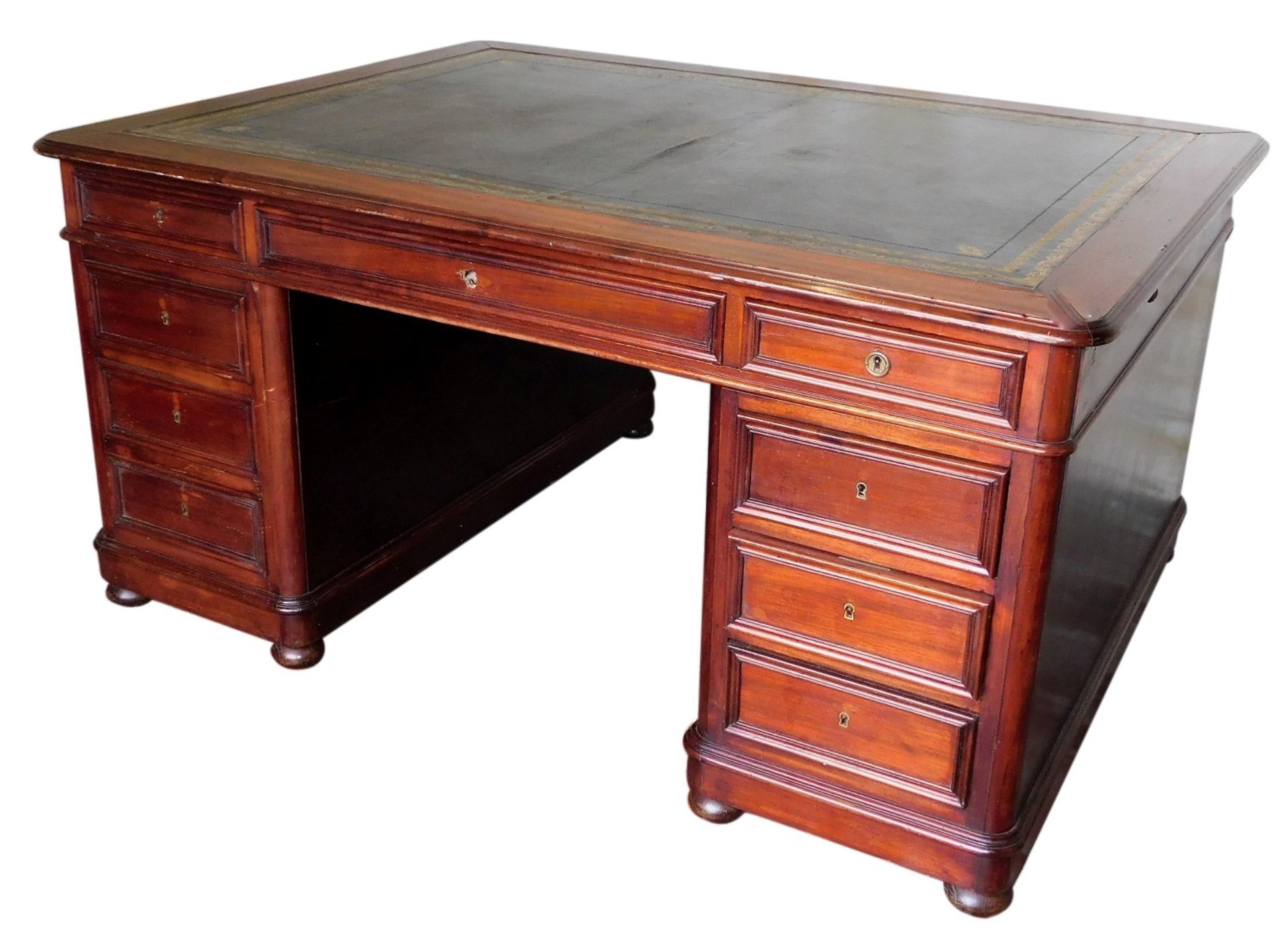 A Victorian mahogany partner's desk, with gilded leather skiver, frieze drawers, and two pedestals w
