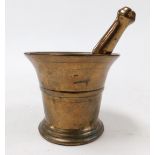 A bronze pestle and mortar.