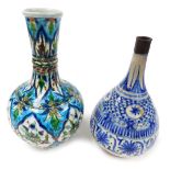 A 19thC Iznik pottery bottle vase, with slightly flared neck decorated with panels of stylised flowe