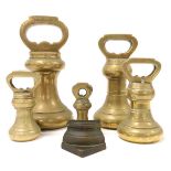 A graduated set of brass bell weights, from 8oz-7lb.