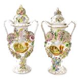 A pair of 19thC Coalbrookdale porcelain flower encrusted vases and covers, each with twin handles an