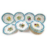 A late 19thC porcelain dessert service, painted centrally with flowers in a blue ribbon border, gilt