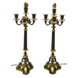 A pair of bronzed and gilt metal table lamps, in Empire style, each with a reeded column, four candl