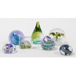 A group of glass paperweights, to include a paperweight of conical design, with a purple and green i