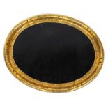 A Victorian ebonised papier mache oval tray, with elaborate gilt border, 79cm x 64cm.