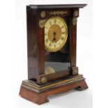 A late 19thC American mahogany cased mantel clock, circular brass dial with chapter ring bearing Rom