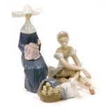 A Lladro porcelain figure modelled as a seated ballerina, 14cm high, together with a Lladro figure g