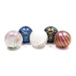 Five Isle of Wight glass orb paperweights, each of differing design and colourway, bearing paper lab