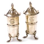 A pair of late Victorian silver pepperettes, each with a flame finial, waved rim and cylindrical bod
