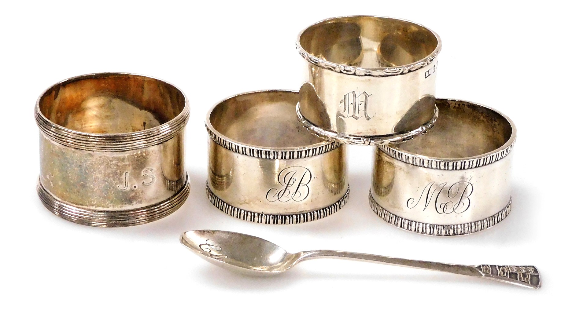 A group of small silver, comprising four napkin rings of differing designs and dates, together with