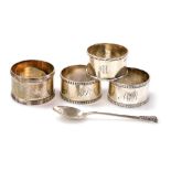 A group of small silver, comprising four napkin rings of differing designs and dates, together with