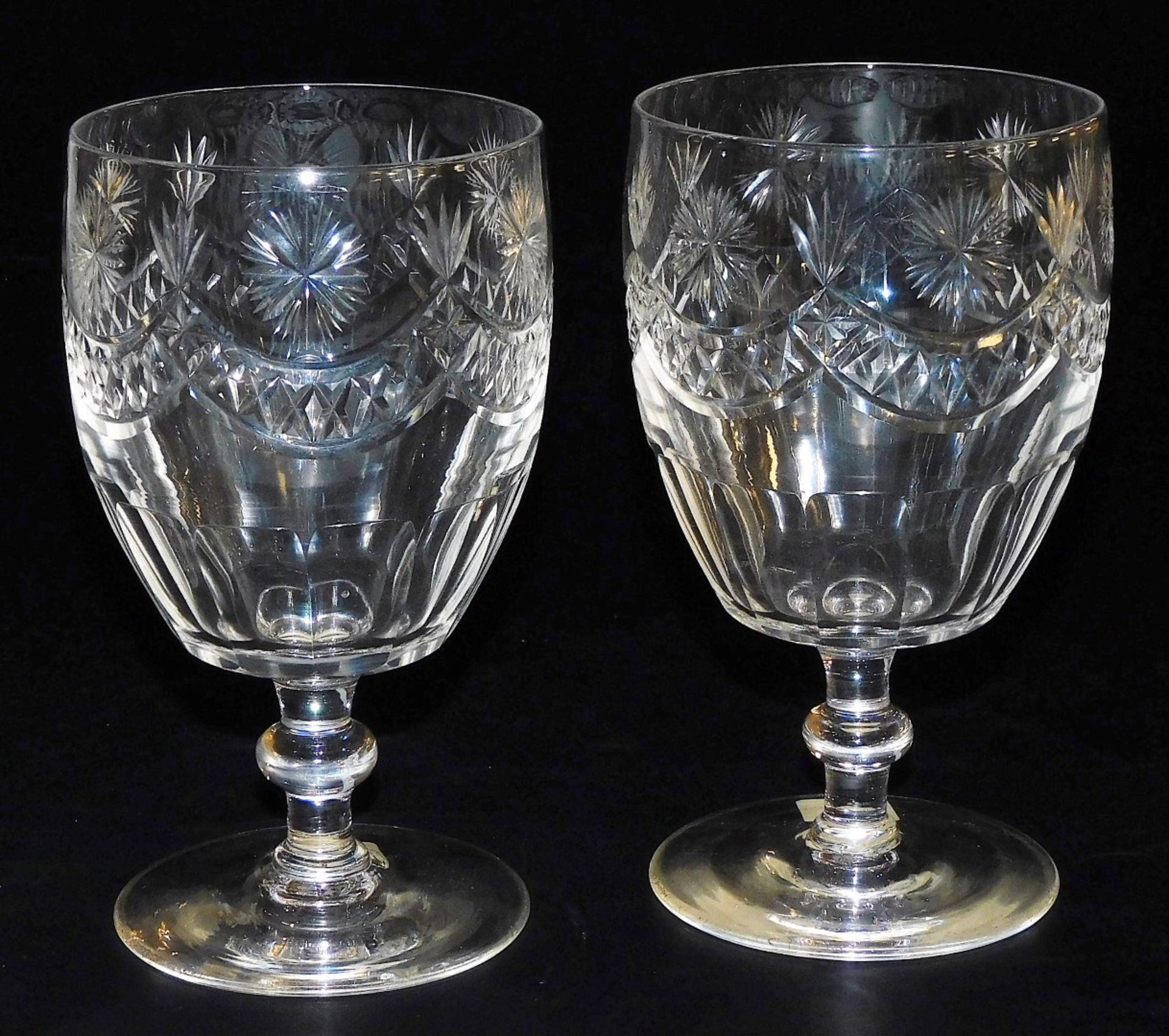 A pair of 19thC bucket shaped cut glass rummers, each decorated with stars and with swags, on a knop