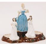 Three Royal Doulton porcelain figures, modelled as Enchantment, HN2178, Embrace, HN4258, and Sentime