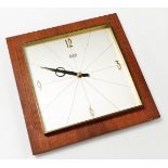 A mid century Secura Elexacta teak cased wall clock, square dial bearing Arabic numerals at quarters