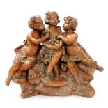 F. Foucher (19thC French). A terracotta figure group of three young girls with flowers, seated on r