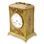 A late 19thC gilt cased mantel clock, with eight day striking movement, having white enamel dial and