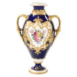 A Royal Crown Derby porcelain twin handled vase, circa 1907, decorated centrally with a floral reser