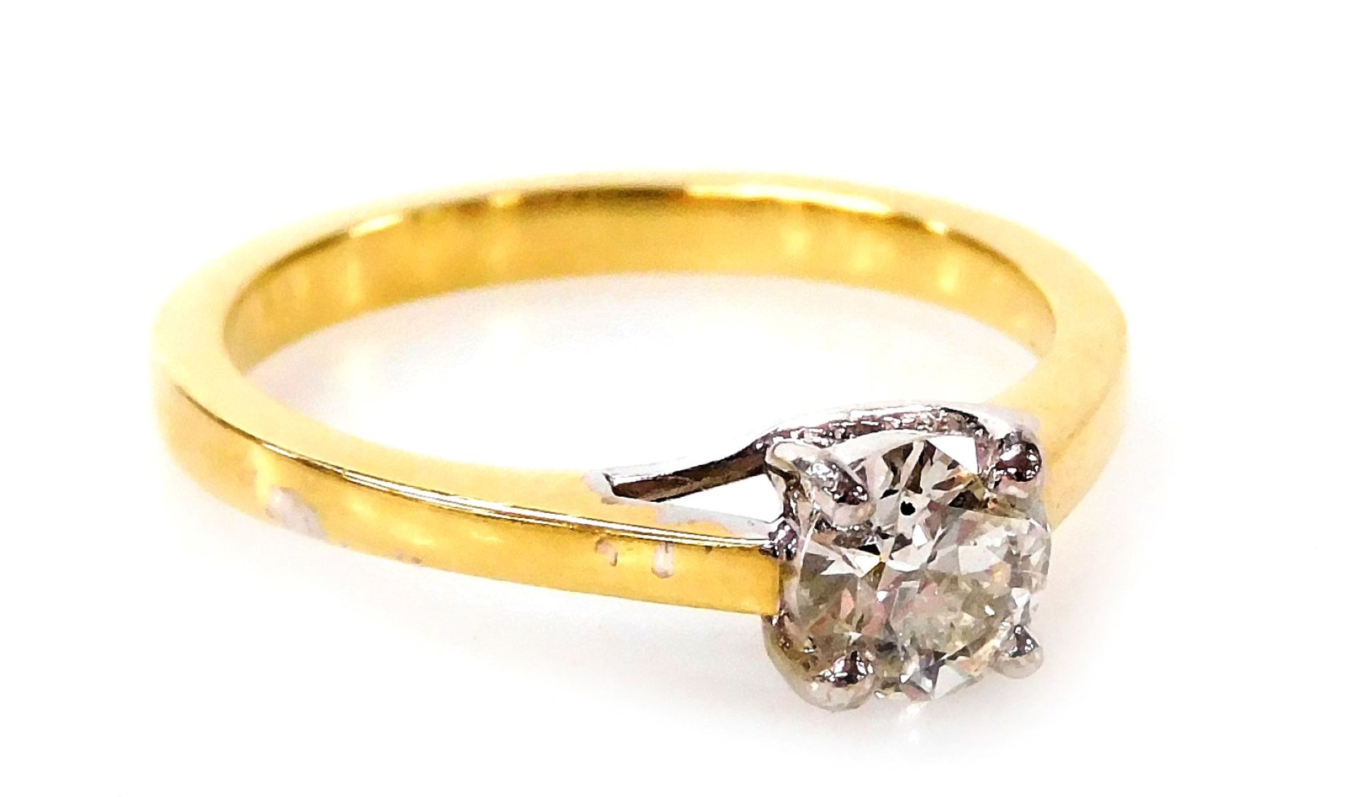 An 18ct gold and diamond solitaire ring, with round brilliant cut diamond totalling 0.53ct, in a fou