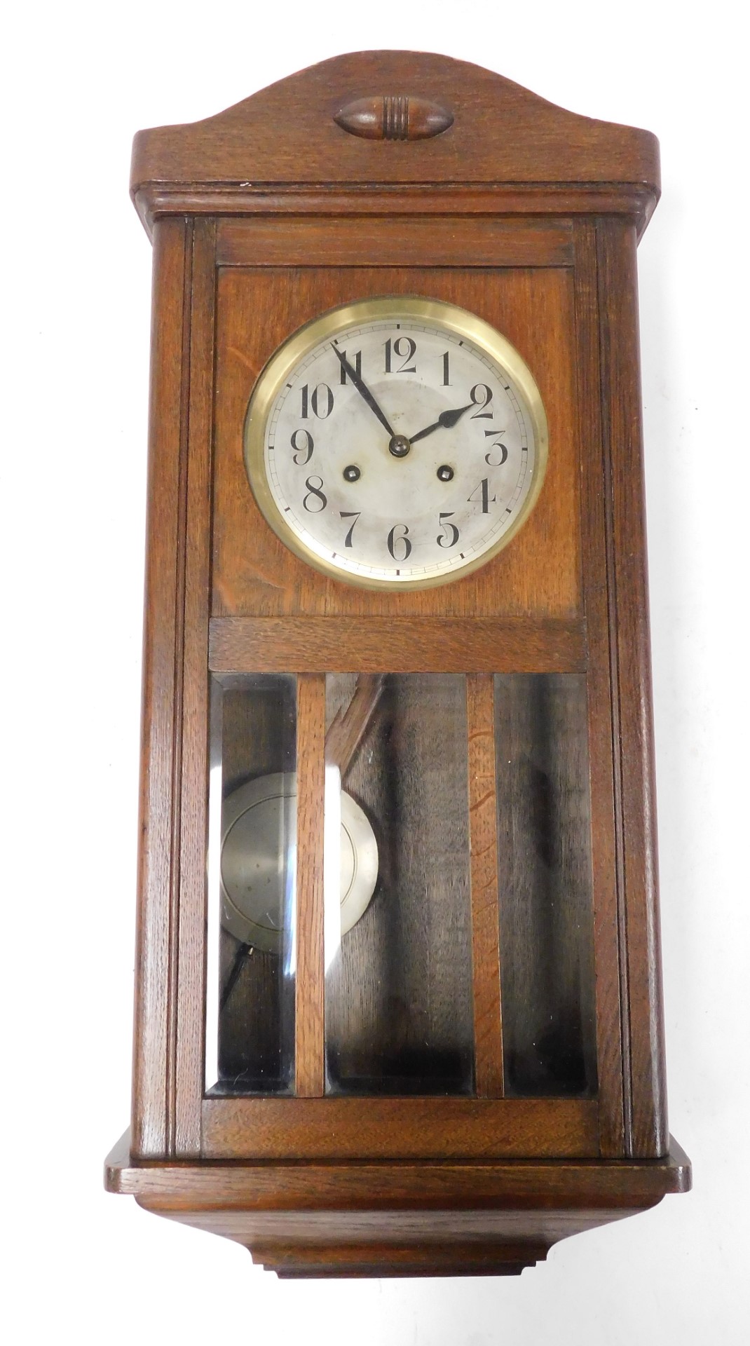 An early 20thC oak cased wall clock, the silvered Arabic numeral dial with brass chapter ring and ei