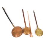A 19thC copper and brass post horn, copper warming pan, further copper warming pan, and a brass warm