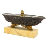 A late 19thC French bronze and ormolu desk stand, of oval fluted and shell scroll form, raised on sc