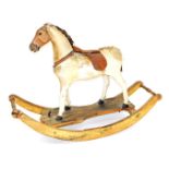 A 19thC rocking horse, the leather horse with leather saddle, pine head, the base with two handles,