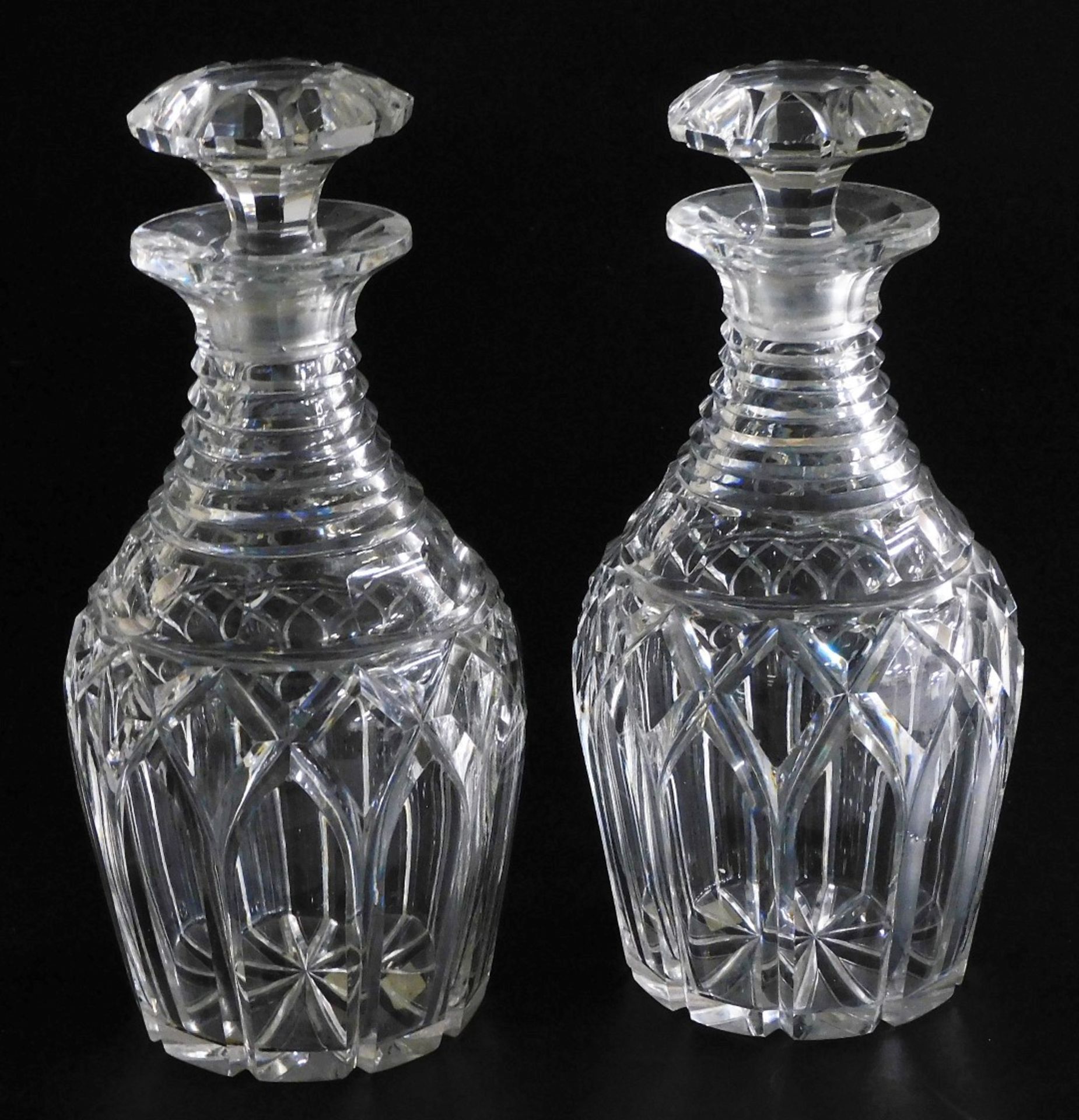 A pair of 19thC cut glass decanters, each with tapering ring neck and mushroom shaped stopper, 25cm