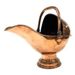 A late 19thC copper helmet shaped coal scuttle, on an associated domed foot with swing handle, 45cm