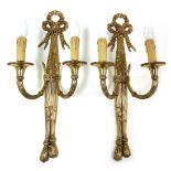 A pair of gilt metal two branch wall lights, in the 19thC manner, with pleated ribbon terminals and