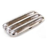 A George V silver cigar case, the rectangular case of moulded form with bright cut decoration, the i