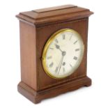 An Edwardian mahogany cased mantel clock, by Pearce & Sons of Leeds, the silver dial with Roman nume