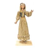 A Continental polychrome painted papier mache figure of a lady, modelled wearing a scarf and with a